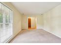 Bright living room with neutral carpet, a large window, and plenty of space to relax or entertain at 763 Brookwood Sw Ter, Lilburn, GA 30047