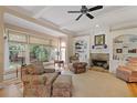 Bright living room features a stone fireplace, built-in shelves, large windows and traditional furnishings at 4874 Registry Nw Ln, Kennesaw, GA 30152