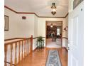 Inviting foyer features hardwood floors, wood trim, and a view into the living room at 1123 Willow Trce, Grayson, GA 30017
