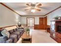 Comfortable living room with wainscotting, neutral carpet, and access to other rooms at 1123 Willow Trce, Grayson, GA 30017