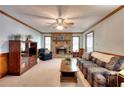 Cozy living room with a stone fireplace, neutral carpet, and ample natural light at 1123 Willow Trce, Grayson, GA 30017