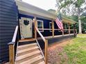 Inviting front porch with a decorative touch, offering a perfect spot to relax and enjoy the outdoors at 124 Dockside Downs Dr, Woodstock, GA 30189