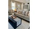 A cozy living room with neutral tones, comfortable seating, and stylish decor at 124 Dockside Downs Dr, Woodstock, GA 30189