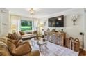 Well-lit living room featuring a comfortable seating area, elegant decor, and a large screen TV at 1600 Belle Isle Ne Cir, Atlanta, GA 30329