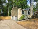View of the side of the house featuring a two car garage, neutral siding, and manicured landscaping at 2489 Smith Ave, Marietta, GA 30064