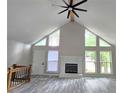 Bright living room with soaring ceilings, a fireplace, and many windows overlooking the outside landscape at 2489 Smith Ave, Marietta, GA 30064