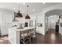 Modern kitchen with white cabinetry, a large center island, and stainless steel appliances at 635 Opera Ln, Alpharetta, GA 30009