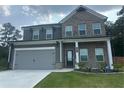 Beautiful two-story home with brick and gray accents, a two-car garage, and an inviting front yard at 495 Sterling Creek Way, Loganville, GA 30052