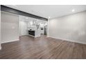 Spacious open-concept living area featuring wood floors and opening into a modern kitchen at 6402 Kensington Ct, Austell, GA 30106
