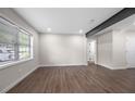 Bright living area featuring hardwood floors, modern recessed lighting, and natural light at 6402 Kensington Ct, Austell, GA 30106
