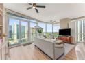 Spacious living room with floor-to-ceiling windows showcasing cityscape, wood floors, and modern decor at 3325 Piedmont Rd Ne # 1907, Atlanta, GA 30305