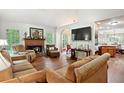 Cozy living room features a brick fireplace and comfortable seating at 408 Victoria Place Dr, Locust Grove, GA 30248