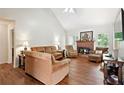 Inviting living room with hardwood floors, fireplace, and ample natural light at 408 Victoria Place Dr, Locust Grove, GA 30248