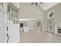 Bright open-concept living room features vaulted ceilings, new flooring, fireplace, and staircase with iron railing at 1950 Stethem Fry, Alpharetta, GA 30022