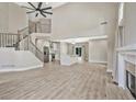 Spacious living room with an open concept design, featuring a grand staircase, fireplace, and modern finishes at 1950 Stethem Fry, Alpharetta, GA 30022
