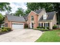 Attractive two-story brick and tan home with a wide driveway and attached two-car garage at 2192 Nine Oaks Nw Dr, Kennesaw, GA 30152