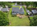 Aerial view of a house with a large backyard featuring a deck, mature trees and a private setting at 1433 Janice Sw Ct, Lilburn, GA 30047