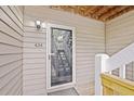 This entryway shows the door to unit 434, stairs and wood siding at 434 Teal Ct, Roswell, GA 30076