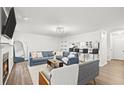 Open-concept living room with modern decor, a fireplace, and a breakfast bar overlooking the kitchen at 434 Teal Ct, Roswell, GA 30076