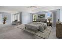 Spacious main bedroom with a tray ceiling, neutral décor, and large windows at 4438 Parmalee Path, Conley, GA 30288