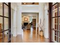 Grand foyer with hardwood floors, white columns, and views into the living spaces at 5284 Vernon Springs Nw Trl, Sandy Springs, GA 30327