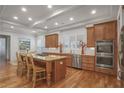 Spacious kitchen featuring granite countertops, a large island, stainless steel appliances and recessed lighting at 6054 Brookhaven Cir, Duluth, GA 30097