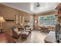 Comfortable living room with ample sunlight, tile flooring, and detailed stone fireplace at 6054 Brookhaven Cir, Duluth, GA 30097