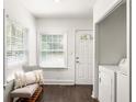 Bright entryway with bench seating, a front door, and a laundry closet at 1170 Westmont Sw Rd, Atlanta, GA 30311