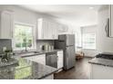 Modern kitchen with stainless steel appliances, granite countertops, and white cabinetry at 1170 Westmont Sw Rd, Atlanta, GA 30311
