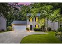 Charming two-story home with gray siding, black shutters, attached garage, and well-manicured lawn at 4800 Countryside E, Stone Mountain, GA 30083