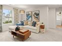 Cozy living room with a sectional sofa, stylish decor, and a large window overlooking the community at 7225 Lacey Lot 147 Dr, Douglasville, GA 30134