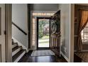 Welcoming foyer with a dark wooden door, stairs, hardwood floors and coat closet at 1120 Bentwater Dr, Acworth, GA 30101