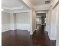 A dining room space featuring elegant molding details, dark hardwood flooring, and neutral walls at 139 Vinca Cir, Suwanee, GA 30024