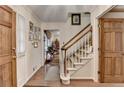Inviting foyer featuring hardwood floors, staircase, and elegant wood trim, creating a warm entrance at 2538 Anchors Way, Snellville, GA 30078
