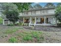 Charming two-story house boasting a spacious covered porch, painted brick, and a two-car garage at 2538 Anchors Way, Snellville, GA 30078