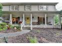 Beautiful yellow door with long covered porch on a two-story house with white painted brick at 2538 Anchors Way, Snellville, GA 30078