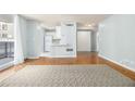 Open-concept living area featuring wood floors and a view to the kitchen with white appliances at 620 Peachtree Ne St # 1001, Atlanta, GA 30308