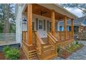 Inviting front porch with wood columns, stylish ceiling fans, and professionally landscaped walkway at 830 Gaston Sw St, Atlanta, GA 30310
