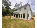Backyard view with lawn, covered patio, and privacy fence at 1679 Eastside Parc St, Atlanta, GA 30316