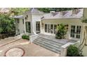 A striking white brick home with multi-level patios and lush landscaping at 3089 Marne Nw Dr, Atlanta, GA 30305