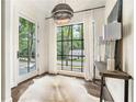Bright foyer with stylish light fixture, large front windows, and decor at 3089 Marne Nw Dr, Atlanta, GA 30305