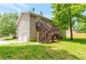 View of house with back porch, basement and garage, plus a fenced-in yard at 400 Rustin Dr, Dallas, GA 30157