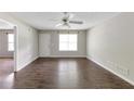 Bright living room features wood floors, a ceiling fan, and natural light at 400 Rustin Dr, Dallas, GA 30157