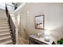 Elegant foyer with staircase, hardwood floors, and stylish console table with artwork at 800 Old Plank Sq, Duluth, GA 30097
