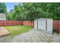 Spacious backyard with wooden fence, storage shed, and stone paver accents at 2026 Patterson Park Pl, Lawrenceville, GA 30044