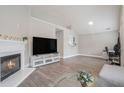 Open living room featuring hardwood floors, a fireplace and vaulted ceilings at 2026 Patterson Park Pl, Lawrenceville, GA 30044