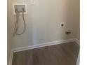 Dedicated laundry area with hookups for washer and dryer on wood look flooring at 2550 Presidents Walk, Tucker, GA 30084