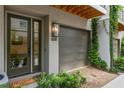 Close-up of a townhome's garage entrance with a modern door and charming landscaping at 658 Bull Se St, Atlanta, GA 30315