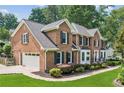 Elegant brick home with a two-car garage and well-manicured landscaping at 742 Maggie Nw Ct, Kennesaw, GA 30144