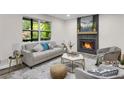 Cozy living room featuring a fireplace, stylish furniture, and ample natural light at 3288 Tarragon Dr, Decatur, GA 30034